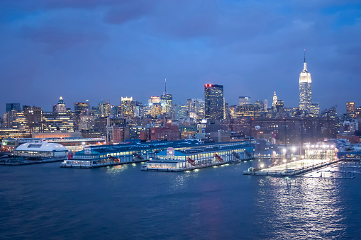 New York City, USA - March 9, 2005 : A view of the panorama of Midtown Manhattan coast with Chelsea piers sports and entertainment complexat at sunset in New York City, USA.