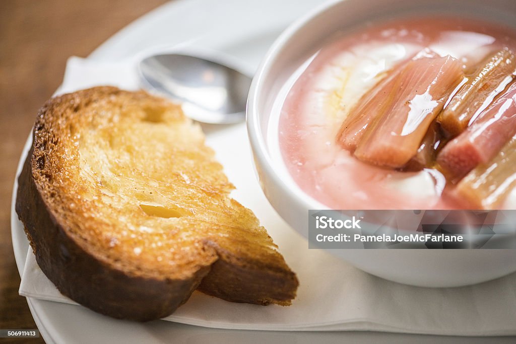 English Breakfast - Stewed Rhubarb, Yogurt and Toast Healthy British breakfast – cooked rhubarb and sauce over yogurt with toast.  London, U.K. Bread Stock Photo