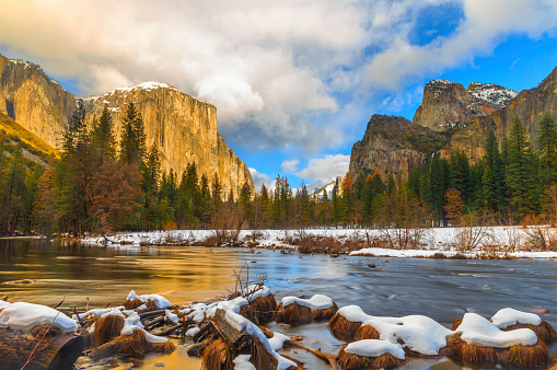 El Capitan Half Dome and Merced River , Yosemite National Park , California in the Sierra Nevada mountains. Snow covered the ground.