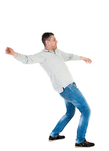 istock Back view man Balances waving his arms. 506913270