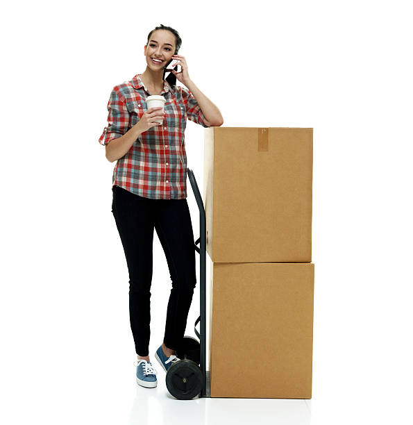 istock Smiling female on mobile and holding coffee cup 506913794
