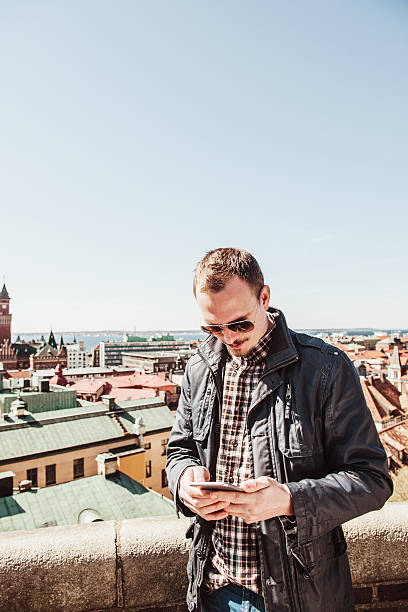 istock Man with smart phone outdoors in city 506914764