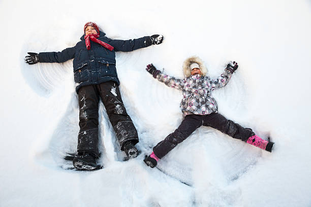 istock Children playing in a snow enjoying winter 506915078