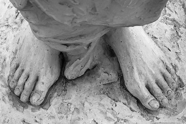 Detail of a marble statue, depicting the foot of the suffering Christ