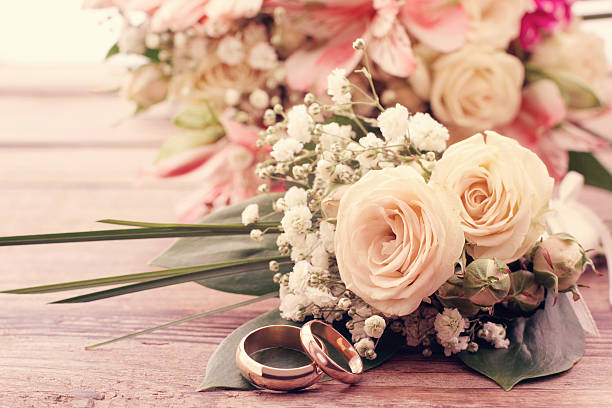 istock White delicate flowers on wooden surface. Wedding bouquet, background. 506916013