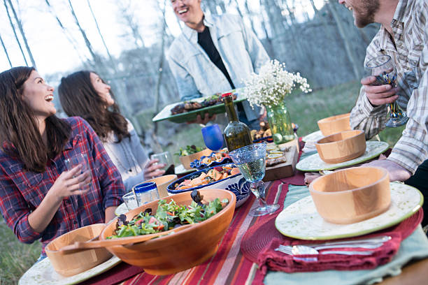 istock Young adults at outdoor dinner party in forest 506916642