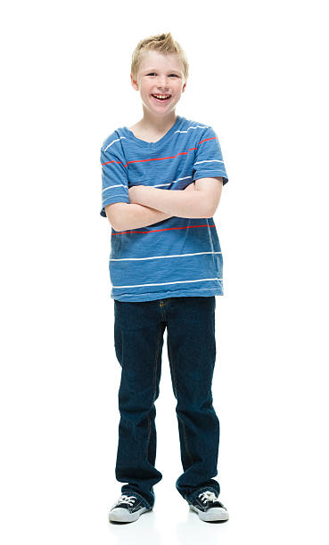 istock Smiling little boy standing with arms crossed 506917098