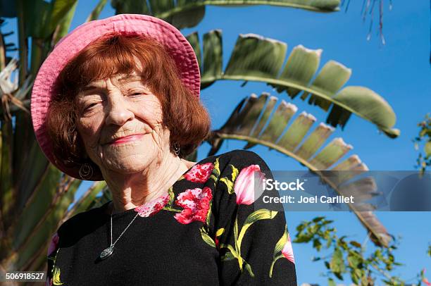 Portrait Of Senior Woman In Pink Hat Outdoors In Florida Stock Photo - Download Image Now