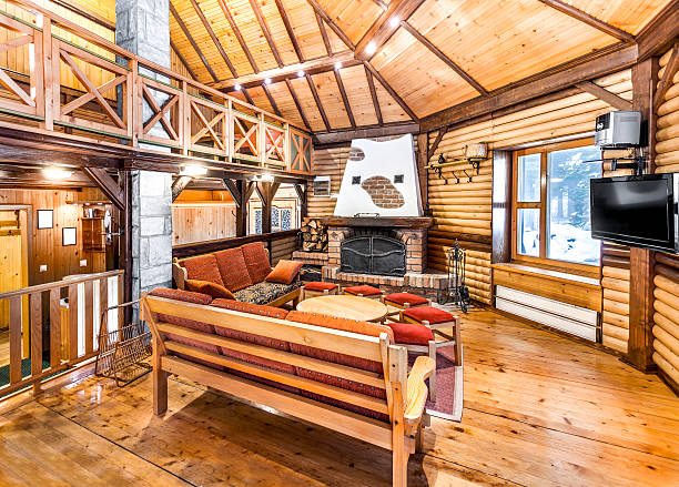 Traditional wooden interior with table and fixtures - mountain hall Traditional wooden interior with table and fixtures - mountain resort chalet photos stock pictures, royalty-free photos & images
