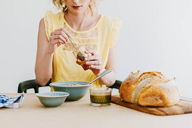 Woman preparing breakfast yogurt and cereals