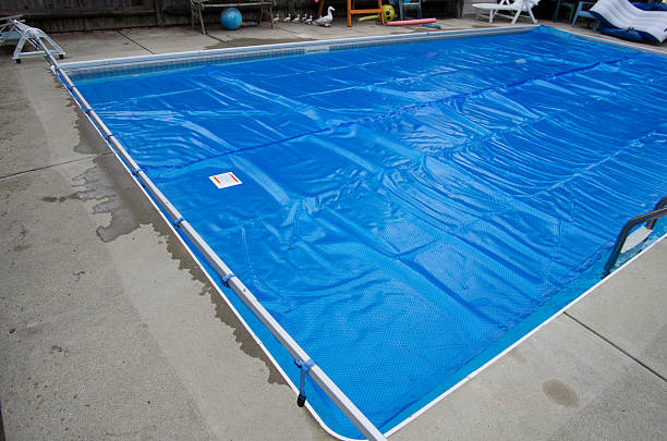 Solar pool cover on swimming pool stock photo