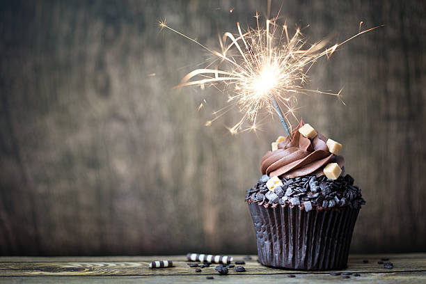 Chocolate cupcake Chocolate cupcake with a sparkler birthday cake photos stock pictures, royalty-free photos & images