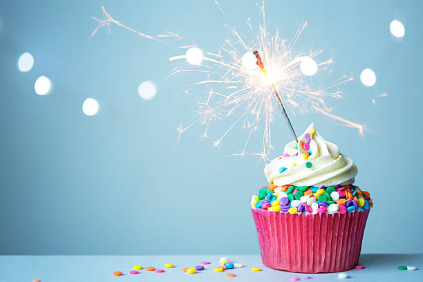 Cupcake with sparkler Colorful cupcake with sparkler cupcake candle stock pictures, royalty-free photos & images