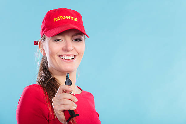 istock Lifeguard woman in cap on duty with whistle. 506920754