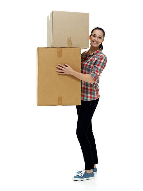 istock Smiling female holding box 506921490