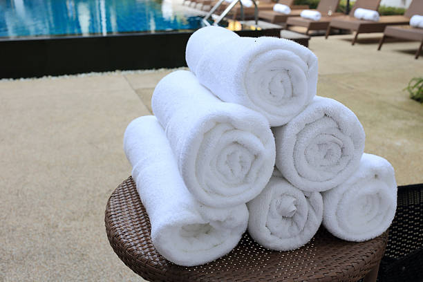 istock rolled towels at swimming pool 506921619