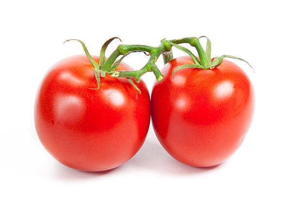 istock three fresh tomatoes with green leaves isolated on white backgro 506922739