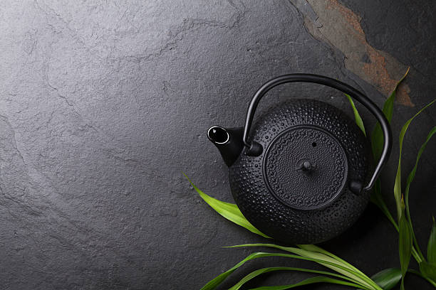 istock Asian teapot over stone table 506922756