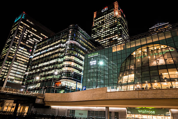 Citibank and Waitrose Headquarters at Canary Wharf, London, UK London, UK - December 21, 2015: modern skyscrapers, including the Citibank building and the headquarters of Waitrose, at the Canary Wharf development on the Isle of Dogs, London, UK. Night shot with no people in the frame. reebok stock pictures, royalty-free photos & images