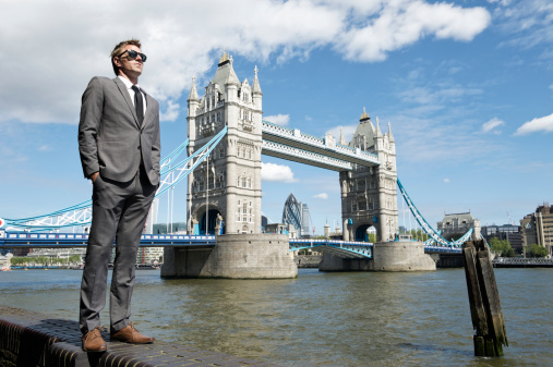 Young businessman standing in front of view of Tower Bridge London England
