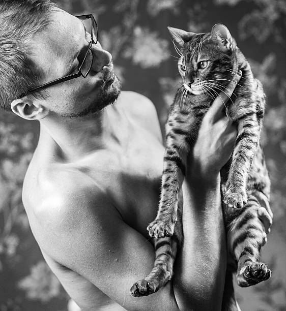 istock Young man with the bengal cat 506923986