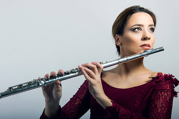 istock beautiful woman with flute 506925082