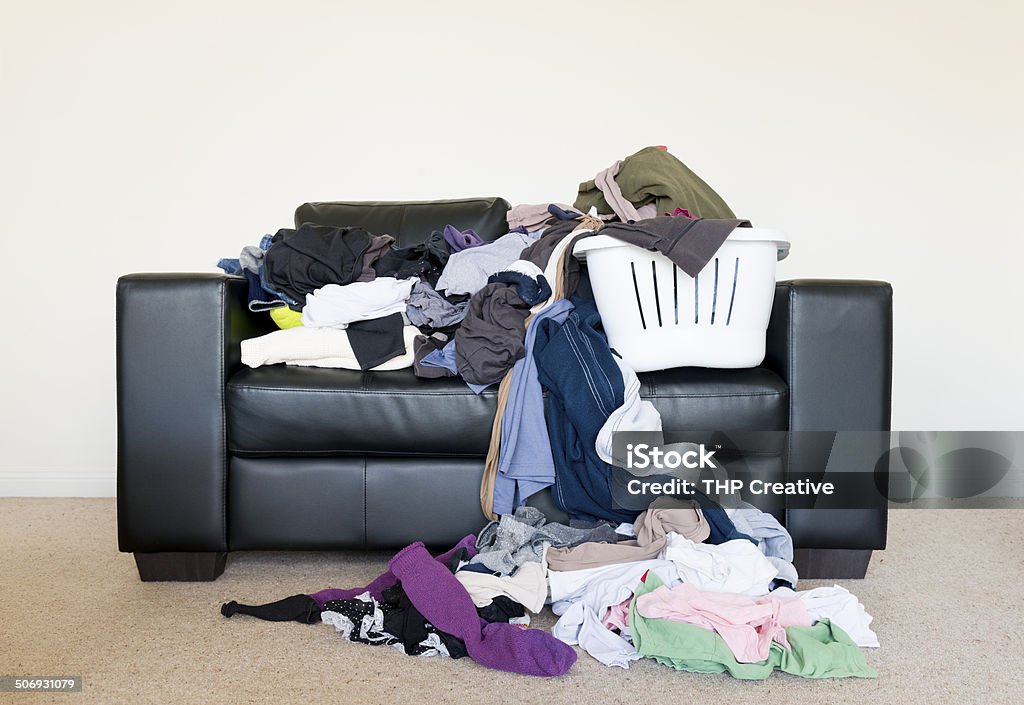 Pile of Washing Housework concept of a large pile of laundry dumped on the couch, waiting to be folded and put away Laundry Stock Photo