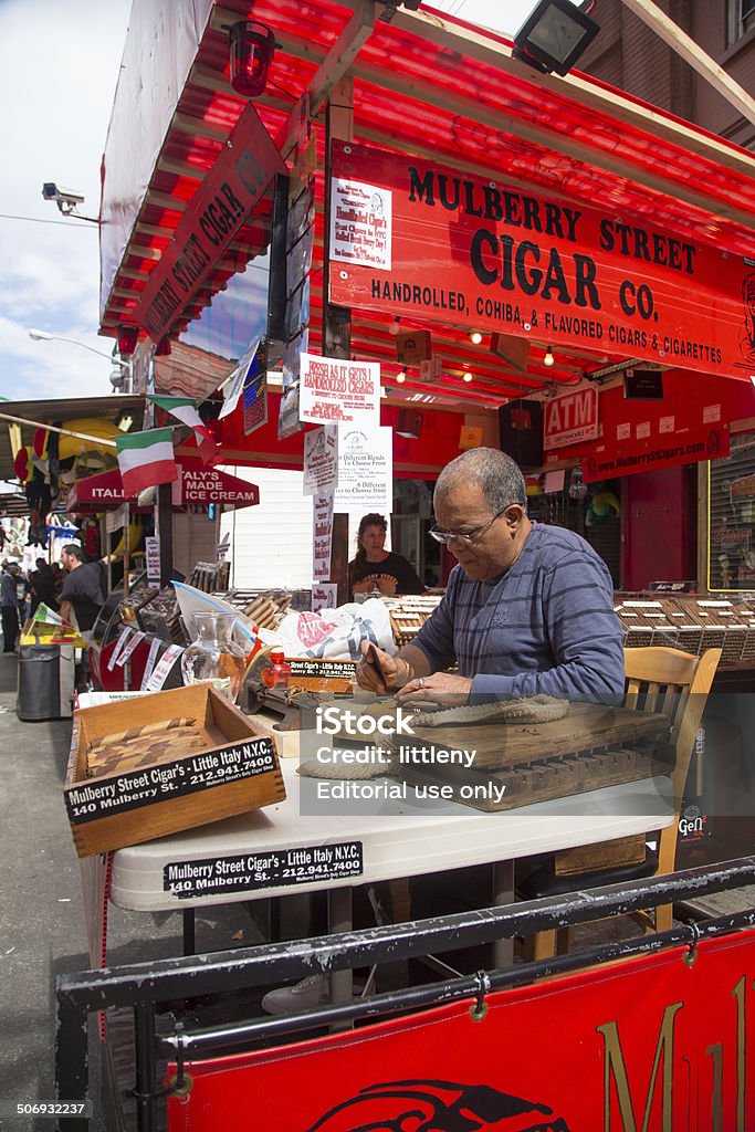 Feast of San Gennaro Vendor New York City, New York, USA - September 13, 2013: Hand rolling cigar vendor at 87th Feast of San Gennaro in NYC.  This annual feast celebrates Italian heritage on the streets of Little Italy. Adult Stock Photo