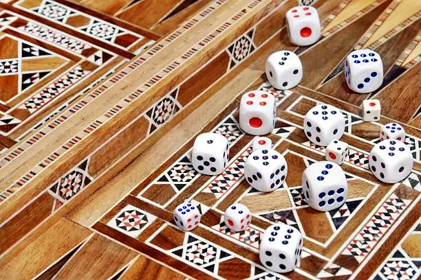 Many roll dices on backgammon board. Background with space for text or image.