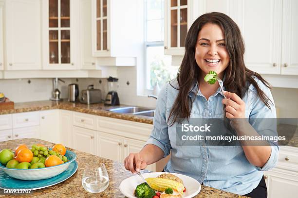 Overweight Woman Eating Healthy Meal In Kitchen Stock Photo - Download Image Now - Overweight, Healthy Eating, Women