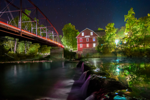 Night view of War Eagle Mill in Arkansas across the river.