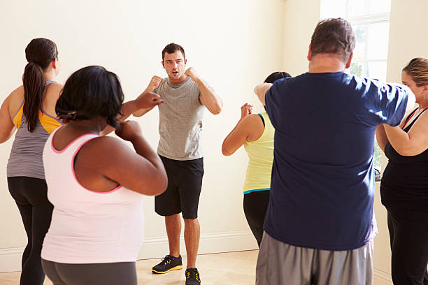 istock Fitness Instructor In Exercise Class For Overweight People 506934495