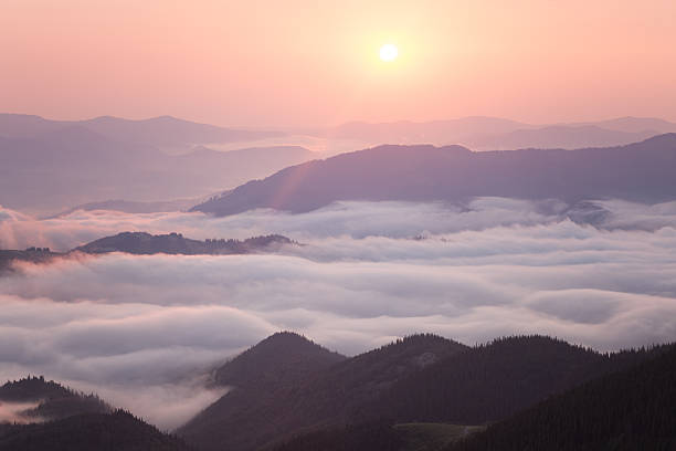 istock Sunrise over cloudy mountain ridge 506935677