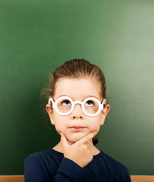 little student - blackboard child thinking little girls photos et images de collection