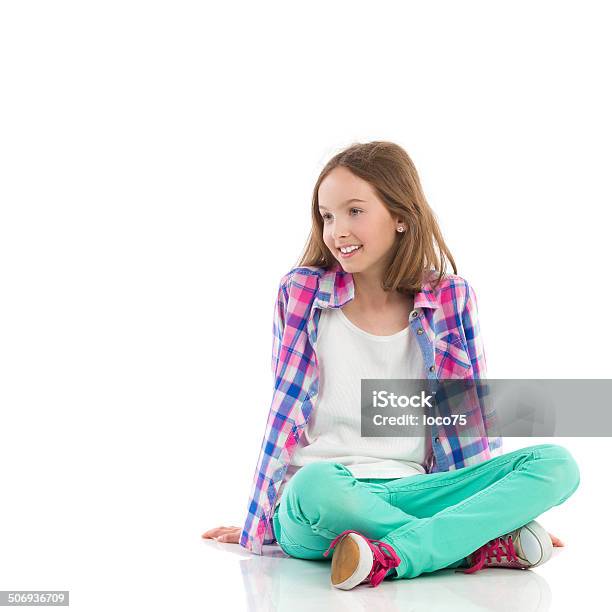 Smiling Girl Sitting With Legs Crossed Stock Photo - Download Image Now - Sitting, Girls, Child