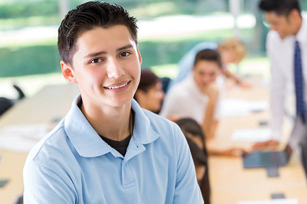 istock Teenage boy smiling in private school classroom 506937295