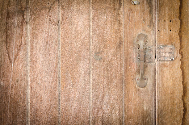 istock Old vintage handle on wooden door. 506973559
