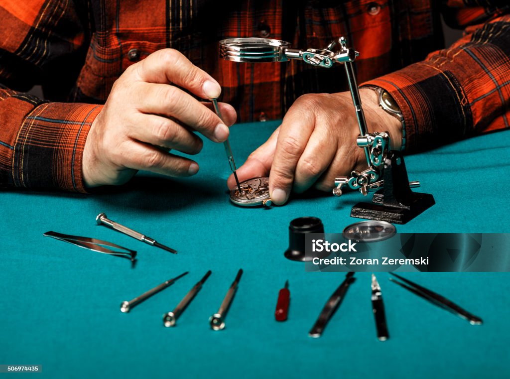 Repairing old pocket watch Pocket watch being repaired by senior watch maker, close-up. 60-64 Years Stock Photo