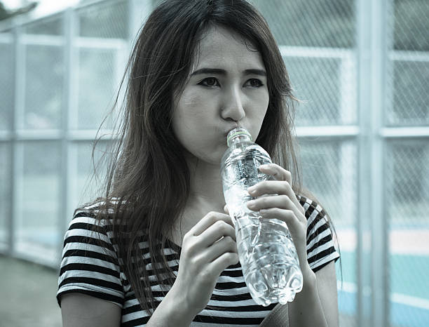istock girl drinking water 506974759