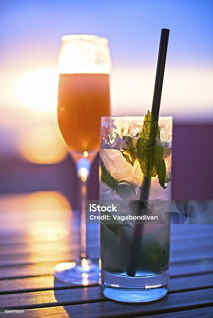 Mojito&Bellini Cocktails on a sunset Lemon - Fruit Stock Photo