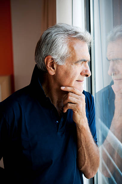 istock Senior Man At The Window 506976679