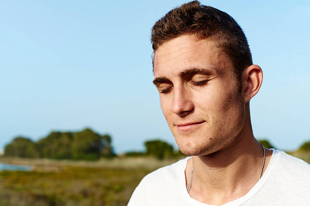 istock young man in nature with closed eyes 506976883