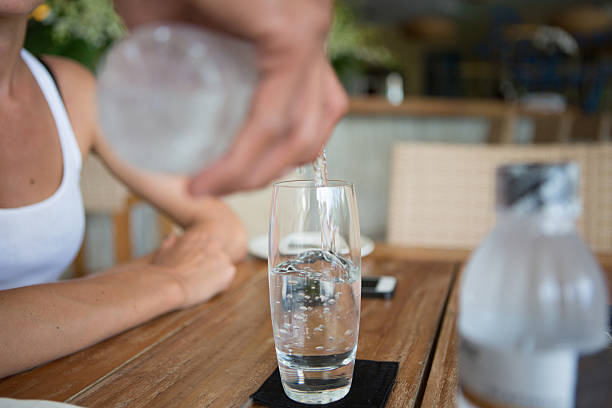 istock Pouring water in glass 506977923