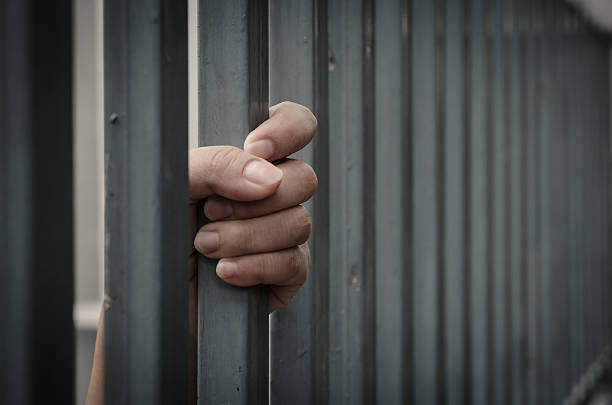 Hand in jail Hand in jail begging social issue photos stock pictures, royalty-free photos & images
