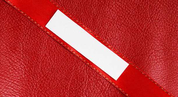 istock Piece scrap paper blank copy space on red leather background 506980297