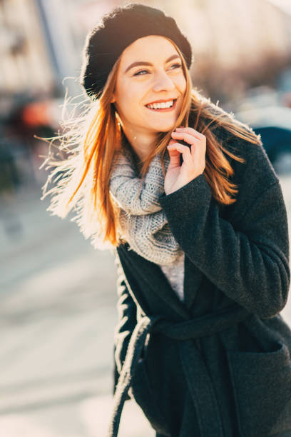 Happy woman walking dawn the street.