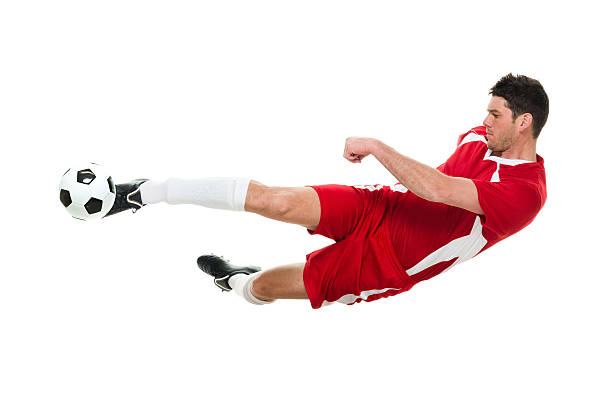 istock Soccer player jumping and kicking the ball 506990554