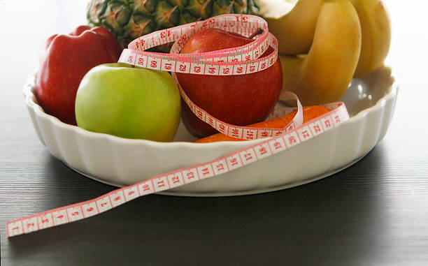 istock pineapple,apples,bananas  and tape measure 506990910