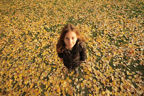 Girl on a walk in an autumn park during a fall leaf