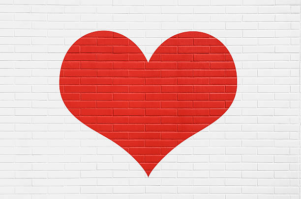 istock Red heart on a white brick wall. Love concept. 506991688